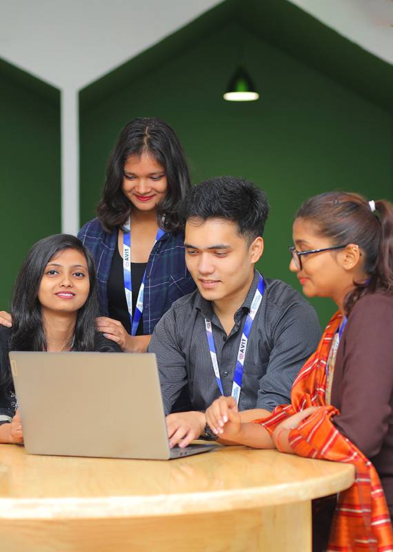 Four AVIT Students together working on one laptop