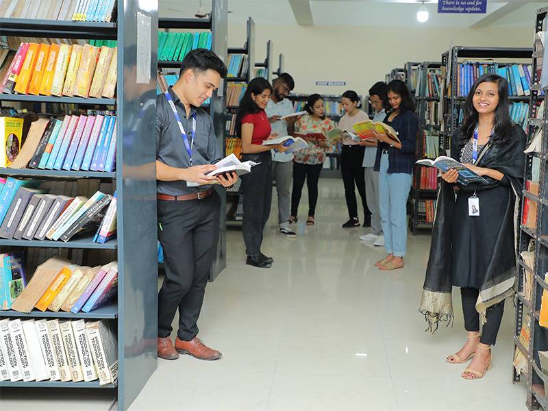Group of students reading books on library
